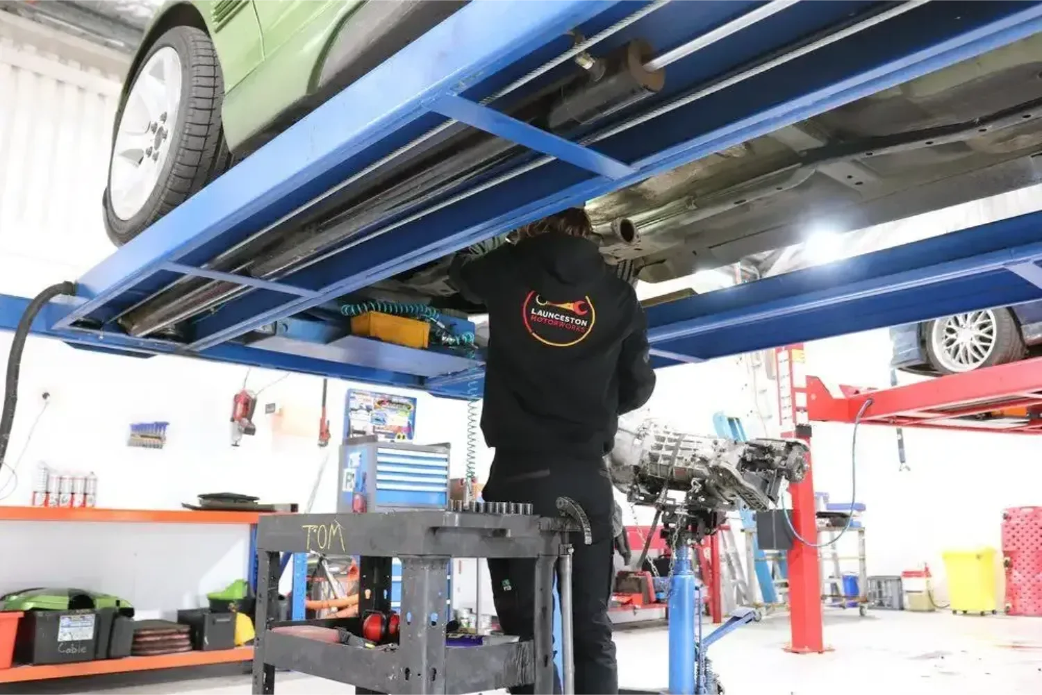 Launceston Motorworks mechanic servicing a vehicle on a hoist