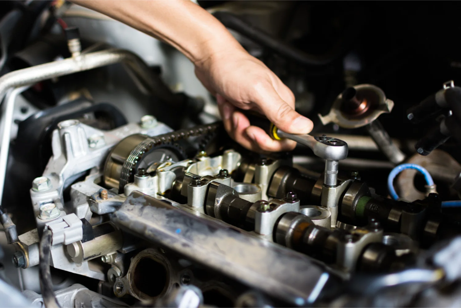 Mechanic working on engine and gearbox components